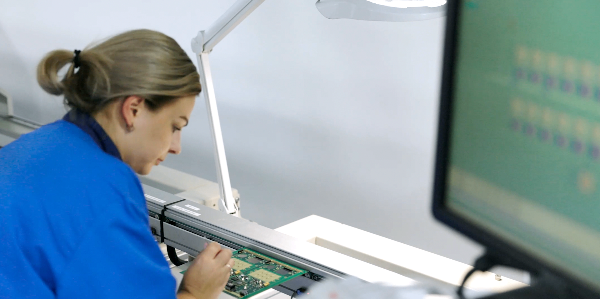 Technician inspecting EAGL IoT circuit board